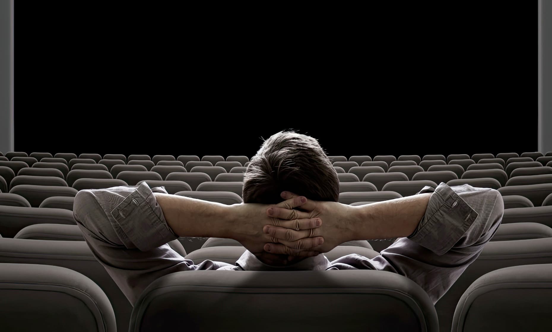 Man Enjoying Movie Theater Projector Screen